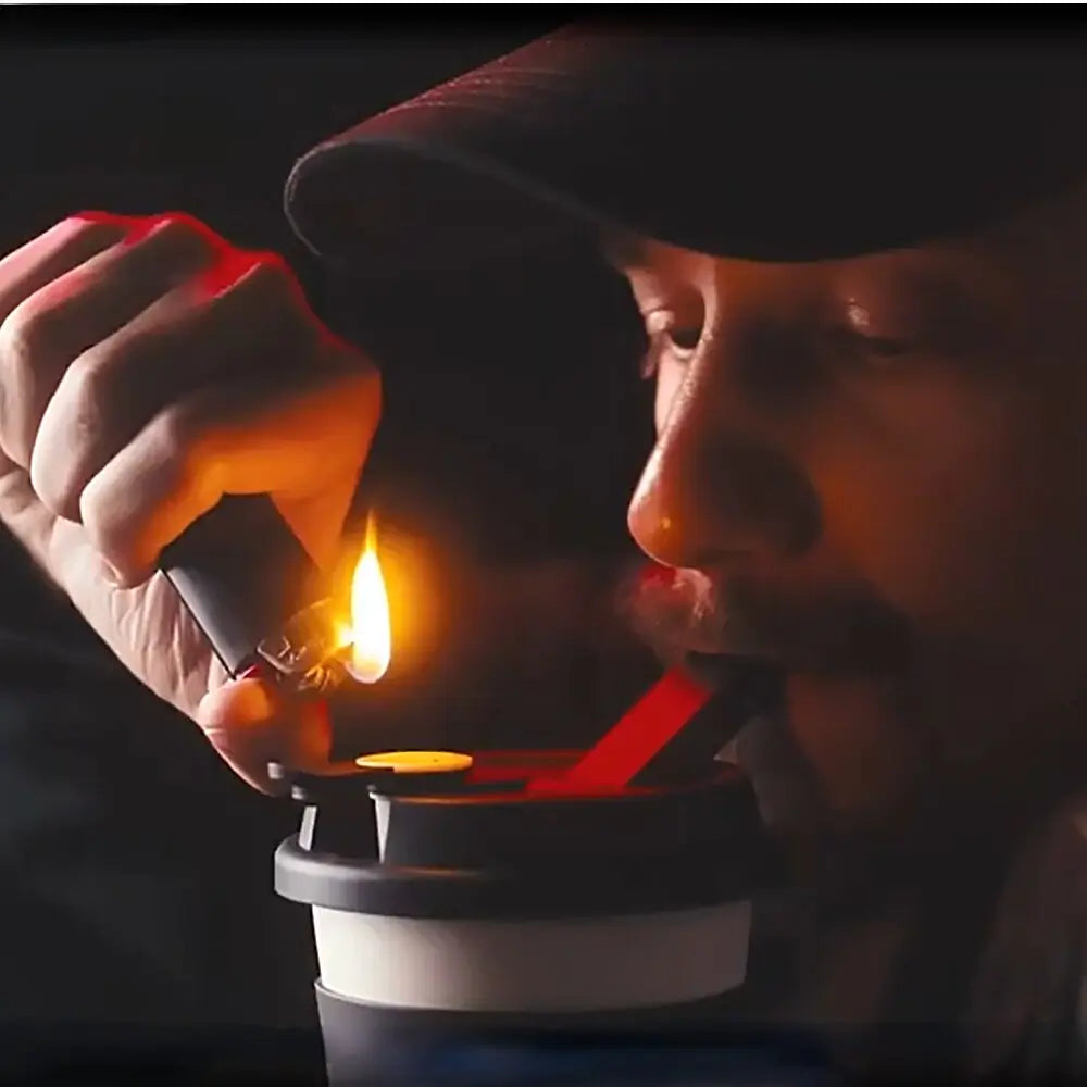 A person in a shadowy ambiance ignites their morning ritual with a biodegradable cup featuring a built-in tobacco bowl, capturing a moment of peace before the day unfolds.